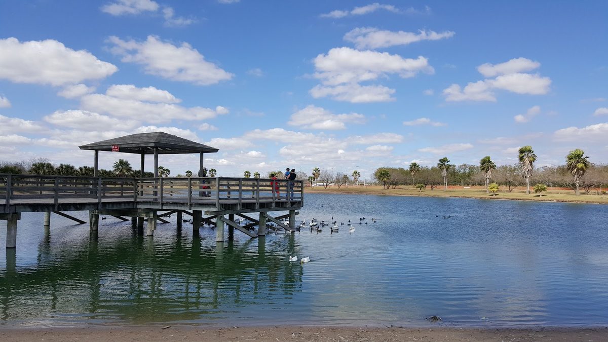 The lake and fishing pier at Edinburg Municipal Park in Edinburg, Texas — part of Ground Patrol's Edinburg pet waste removal service area